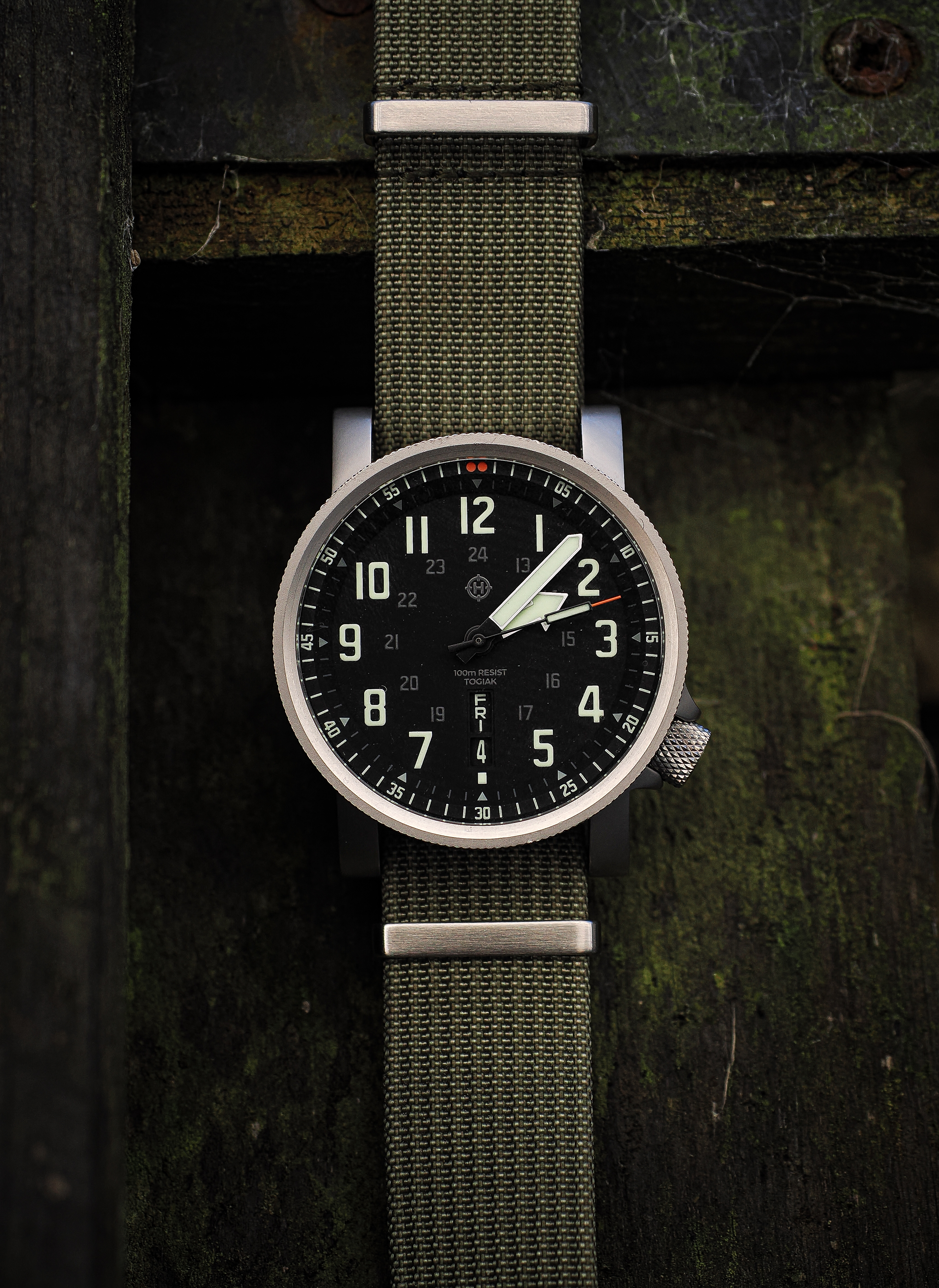 HELM Togiak Scout photographed vertically against dark weathered wood