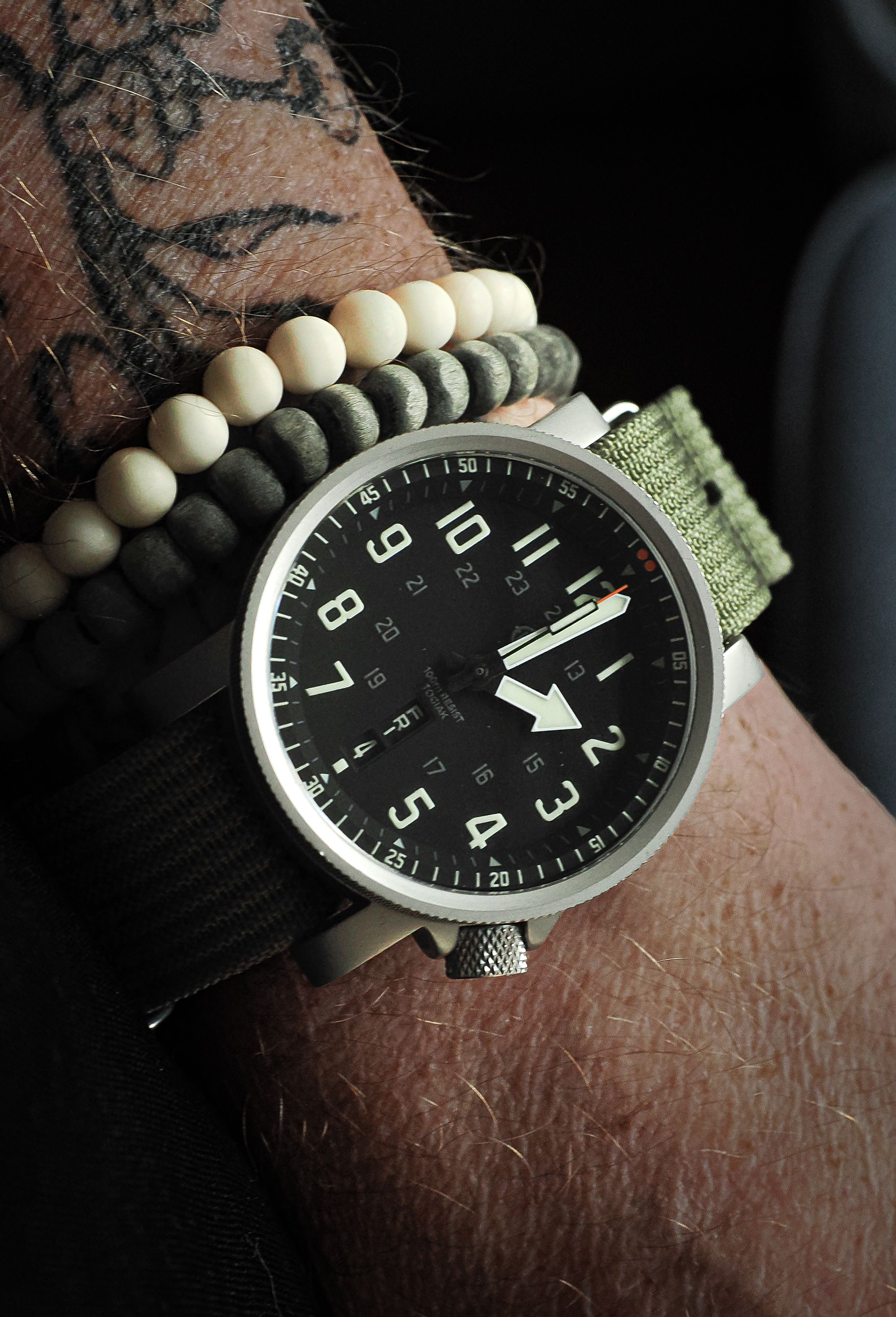 HELM Togiak Scout worn on the wrist with olive nylon strap
