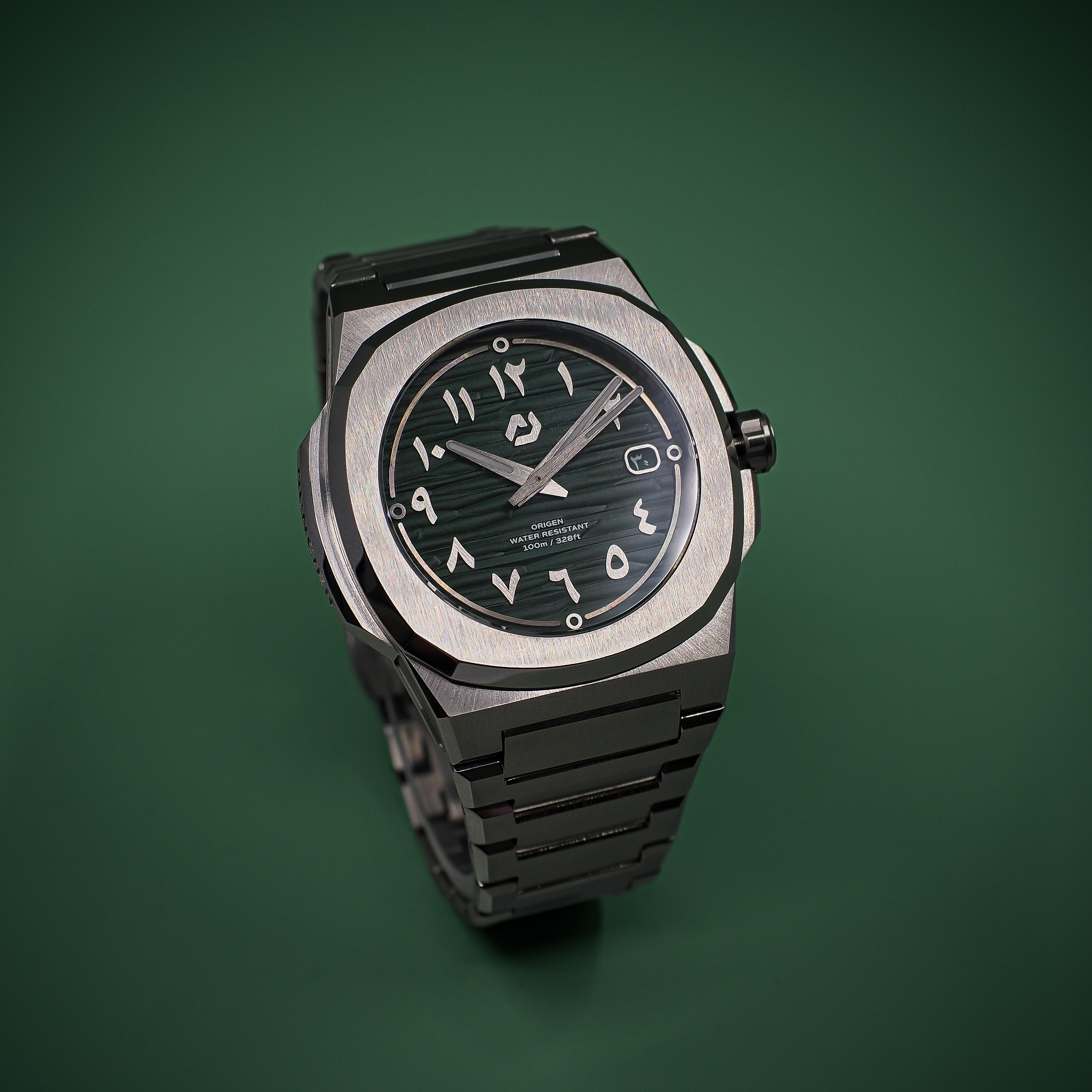 Nuncier Origen green dial studio product photograph on integrated bracelet