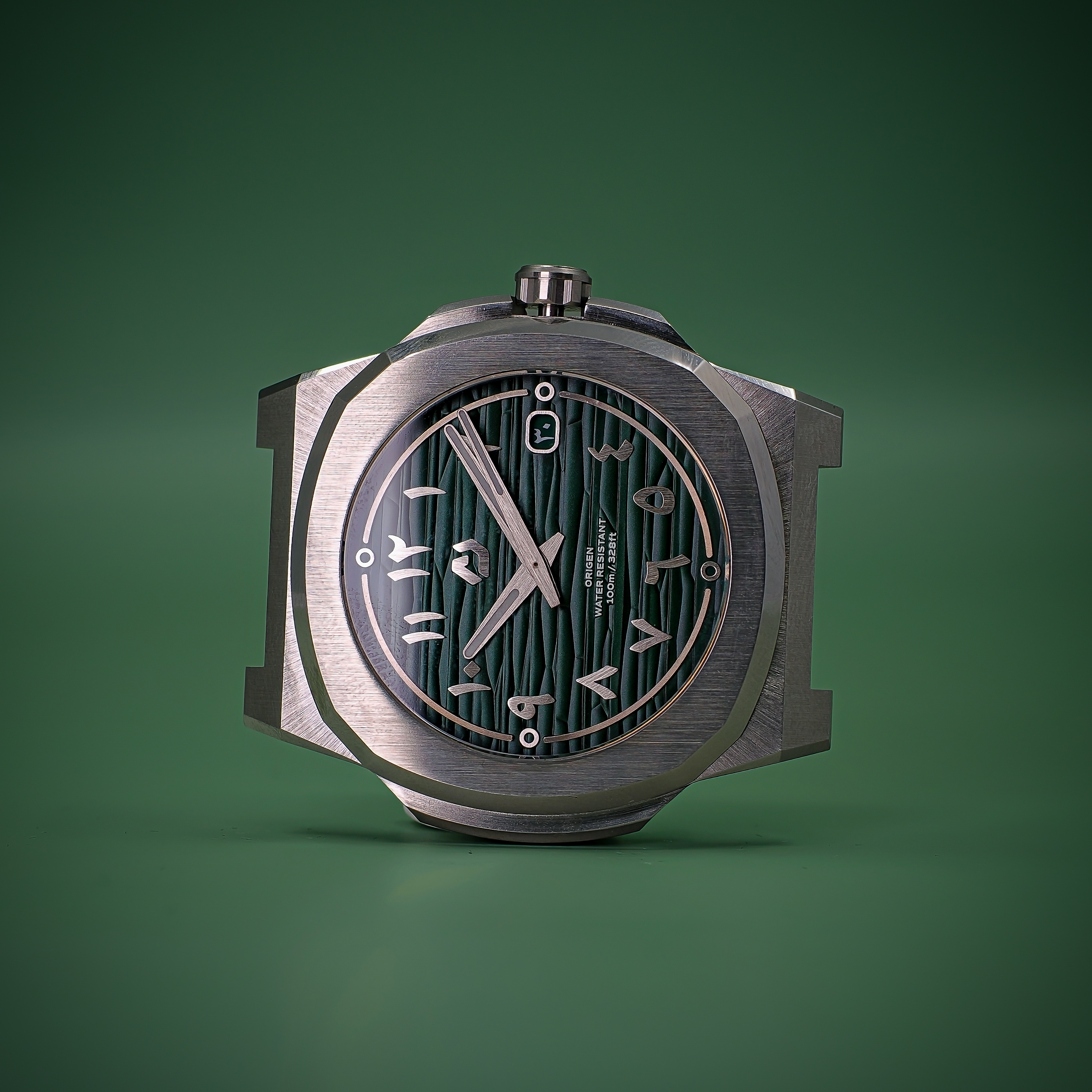 Front studio photograph of the Nuncier Origen green Arabic numeral dial